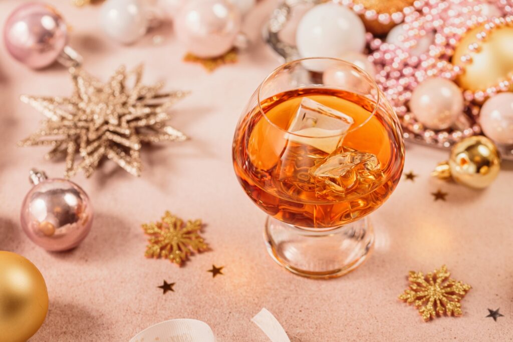 Brandy glass with ice among holiday ornaments